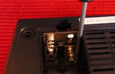 [Removing screws from chassis]