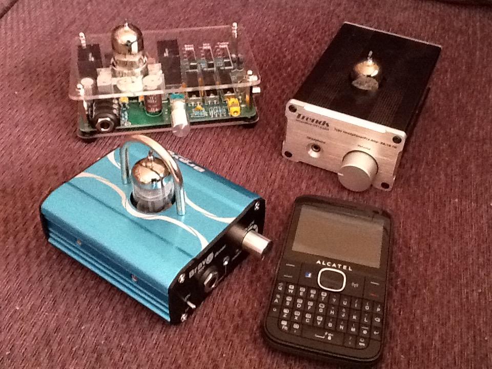 [The three amplifiers beside a mobile device]